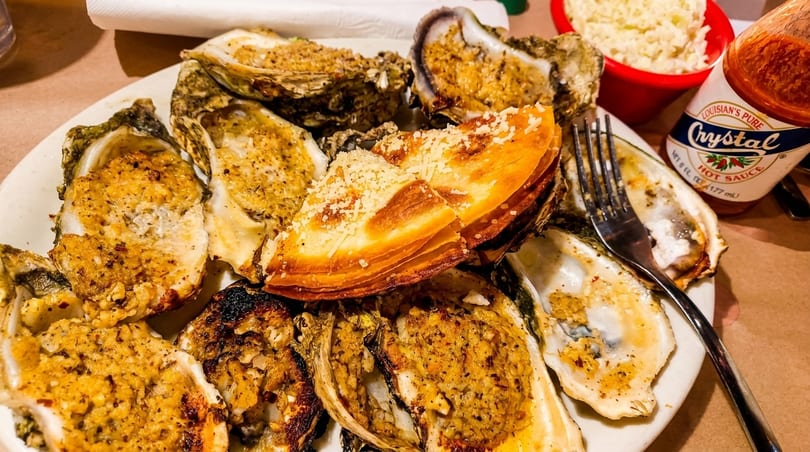 Baked oysters with parmesan and Crystal hot sauce on the side