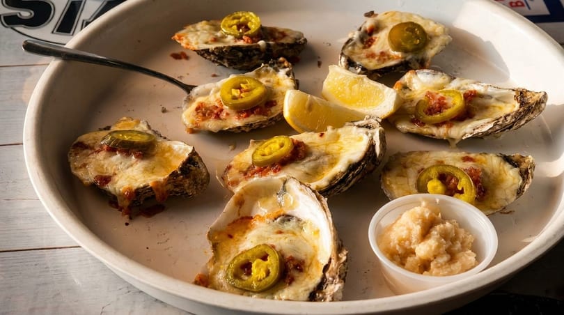 Baked oysters with jalapenos, cheese, and lemon with horseradish